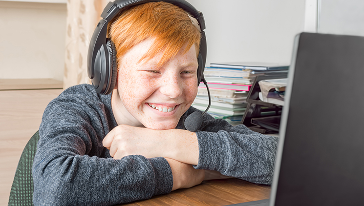 child-using-laptop-and-headphones