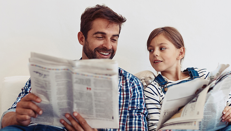 father-and-daughter-reading-newspaper